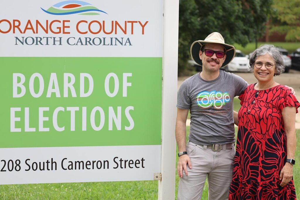 María standing with her son, Cristóbal at the Orange County Board of Elections