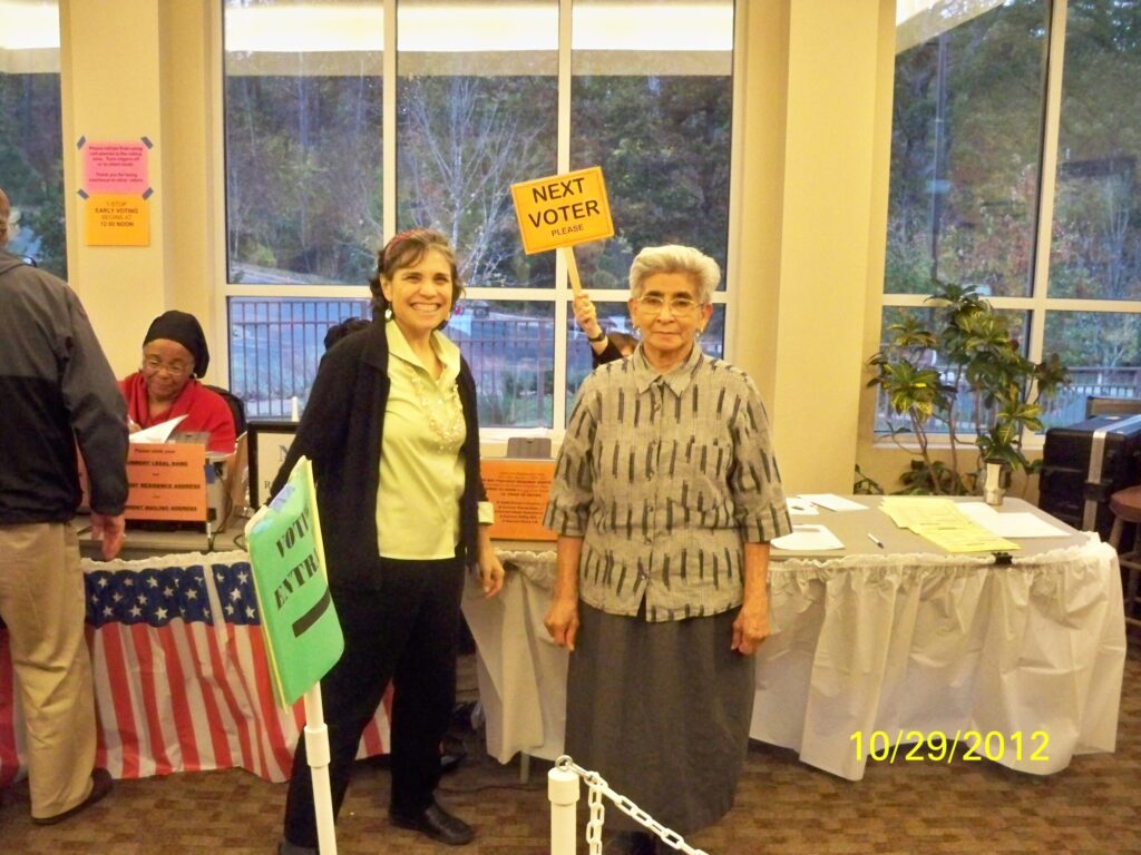 Maria helping a new voter navigate the system